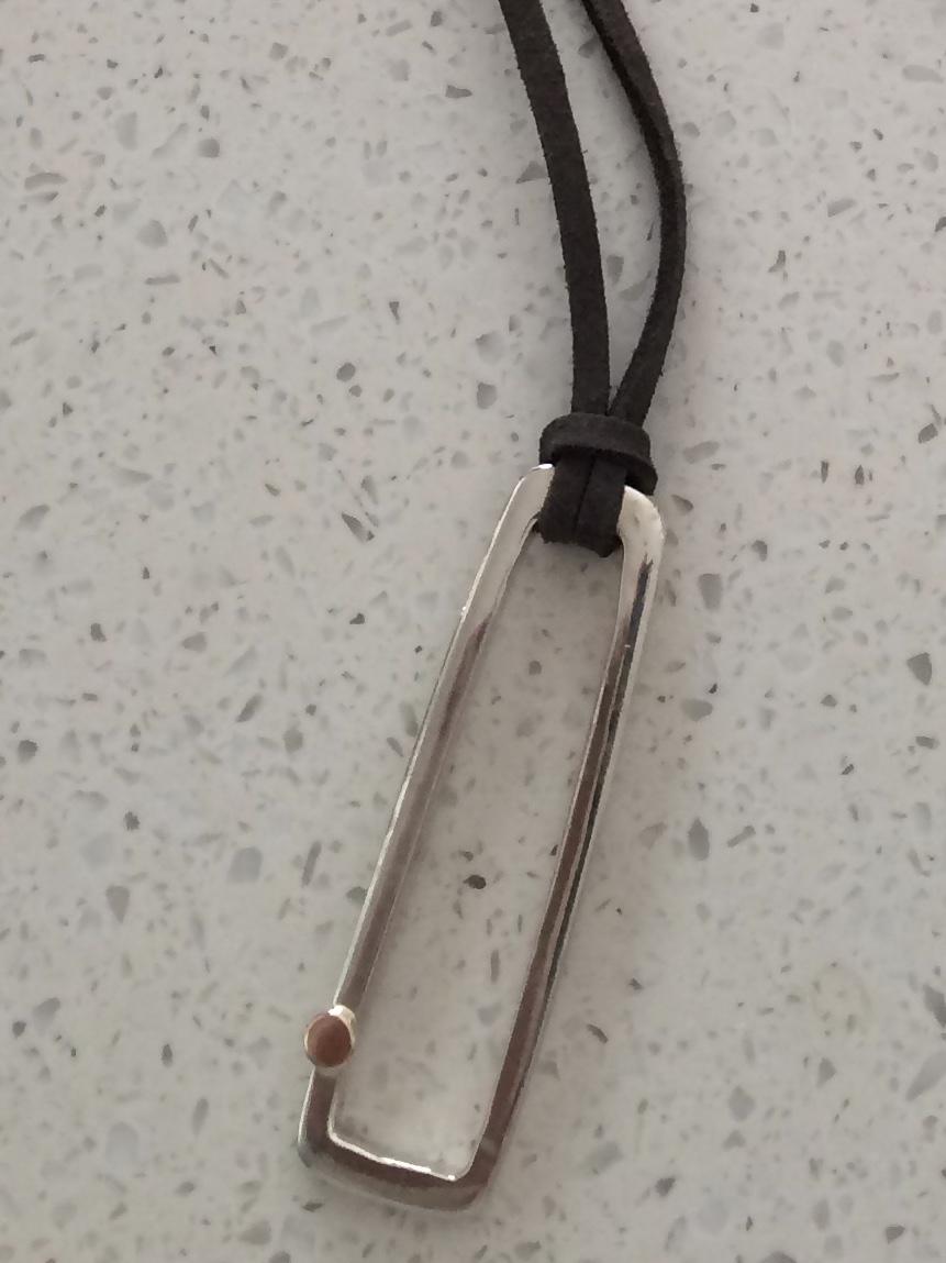 Rectangular sterling 9ct gold pendant on adjustable leather 