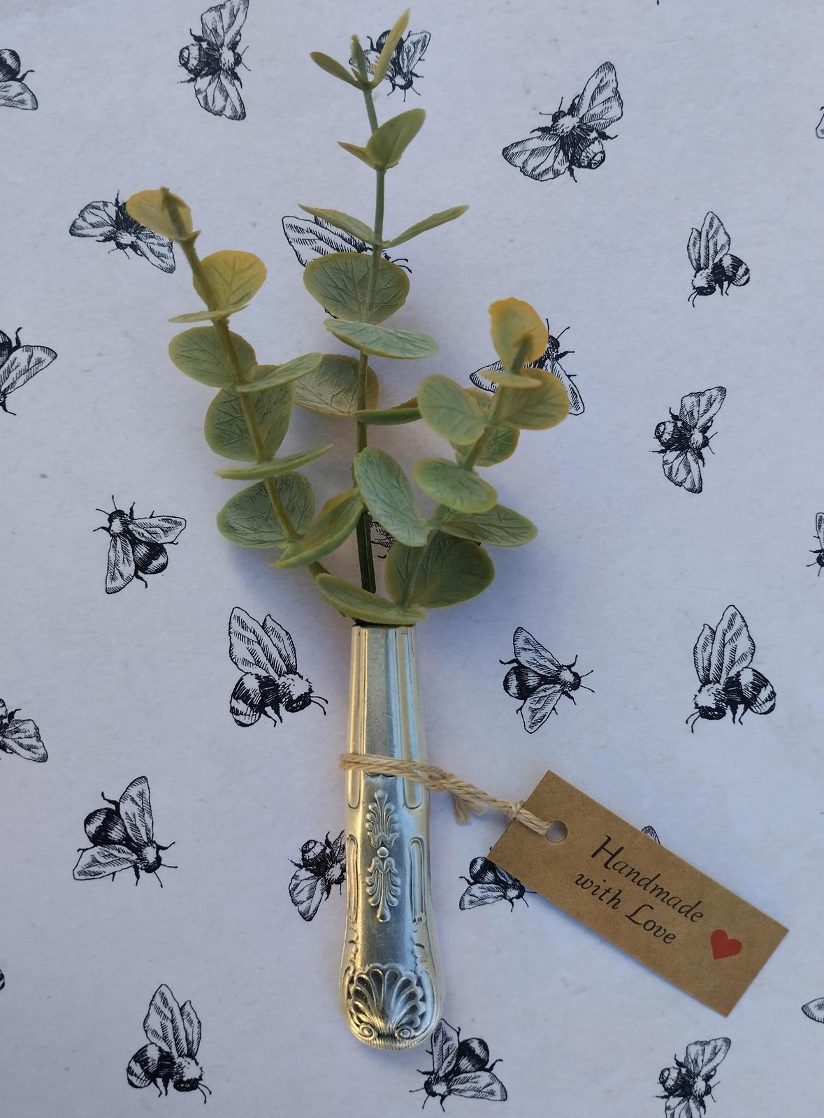 Silver knife handle magnetic vase.