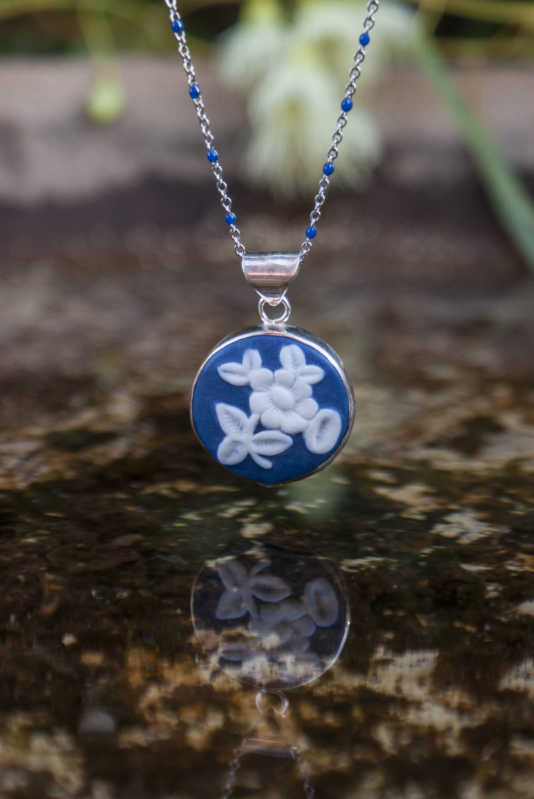 Hand carved porcelain set in silver cameo pendants