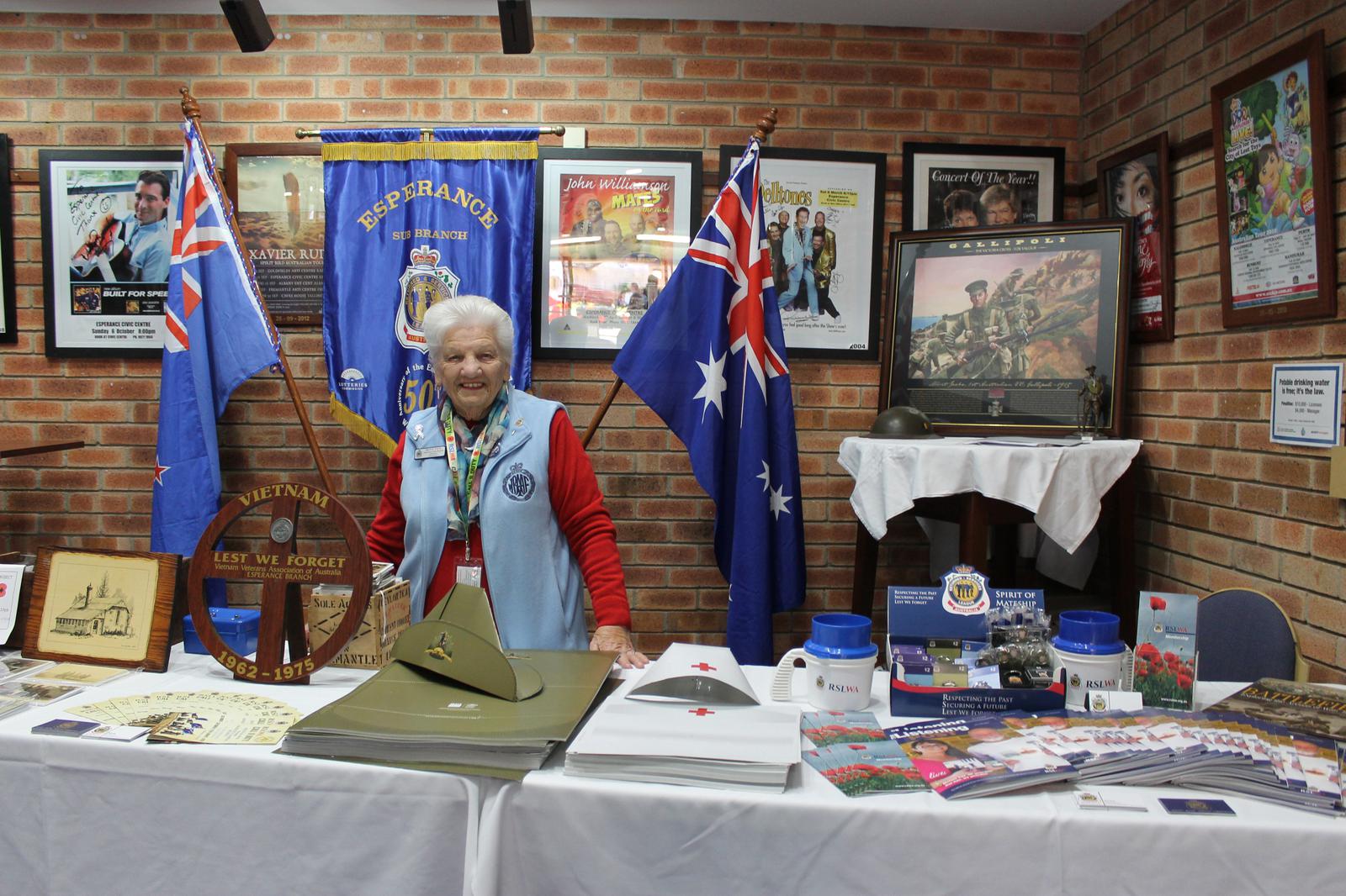 A volunteer ready to make hats with children and share a story.